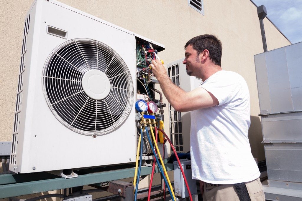 HVAC technician working on condensing unit