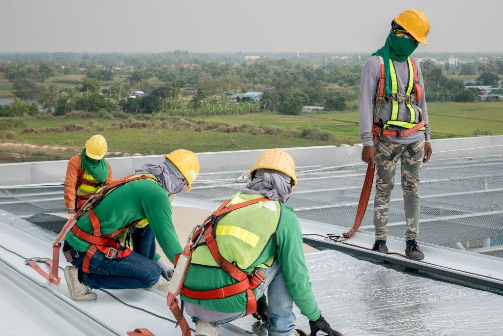 workers installing a commercial roof