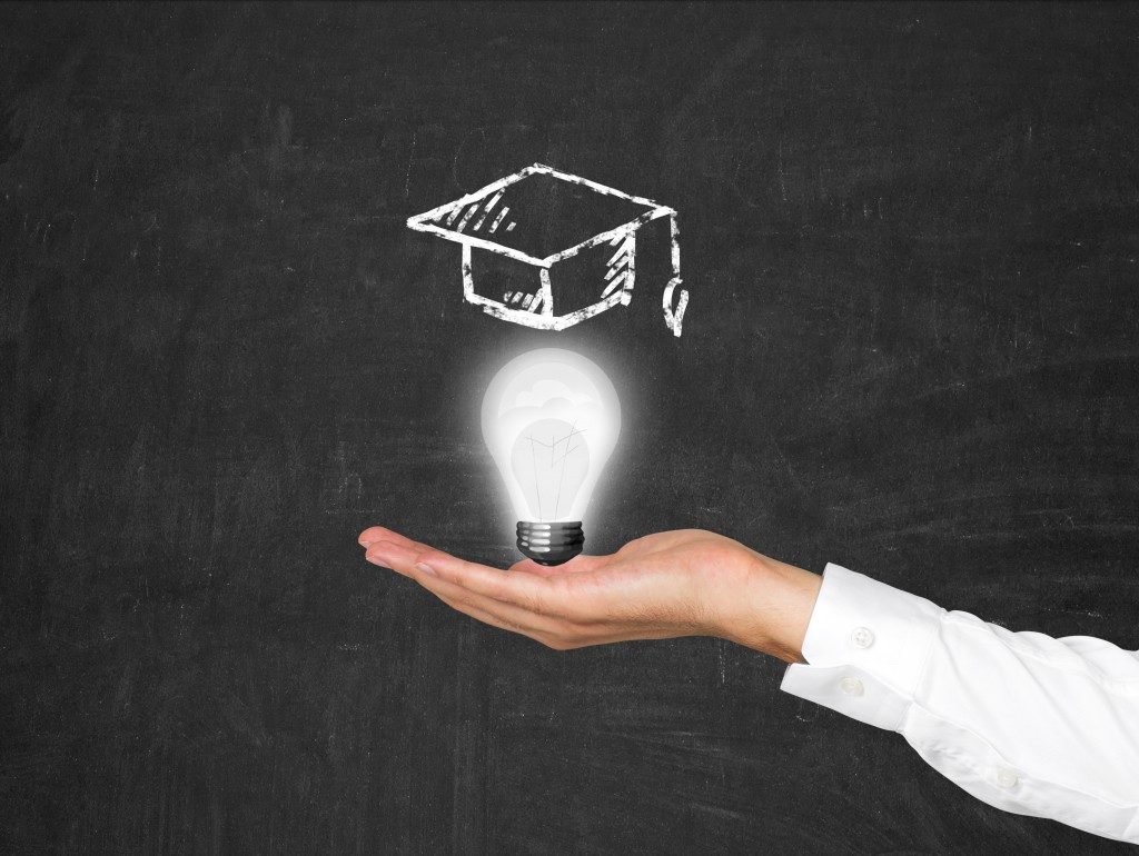 education concept with lightbulb and toga cap