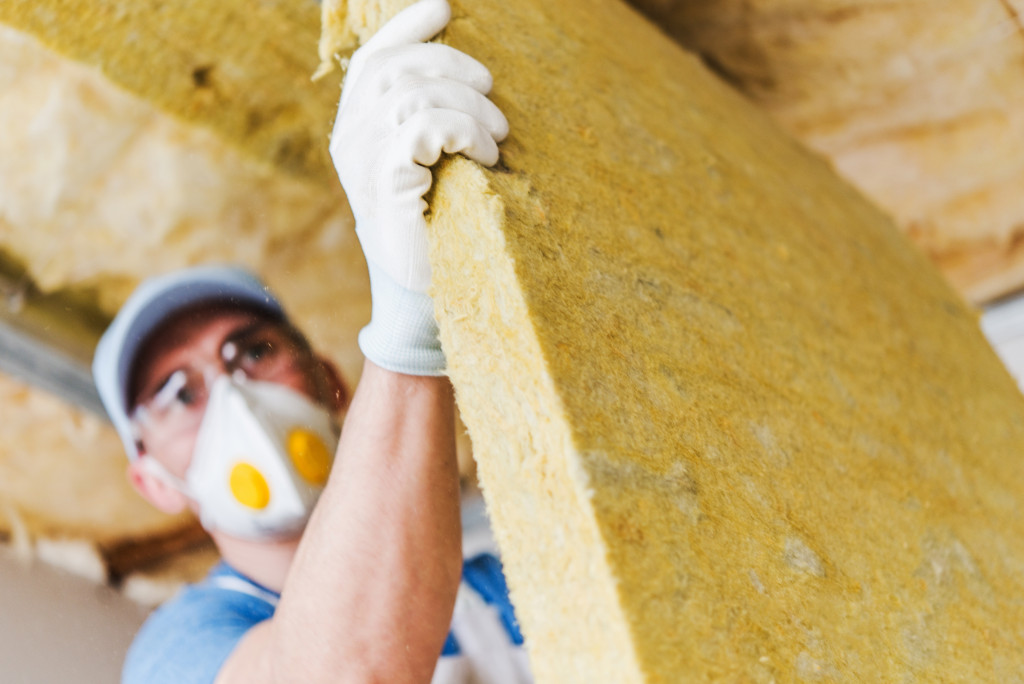 Man holding insulation to be installed