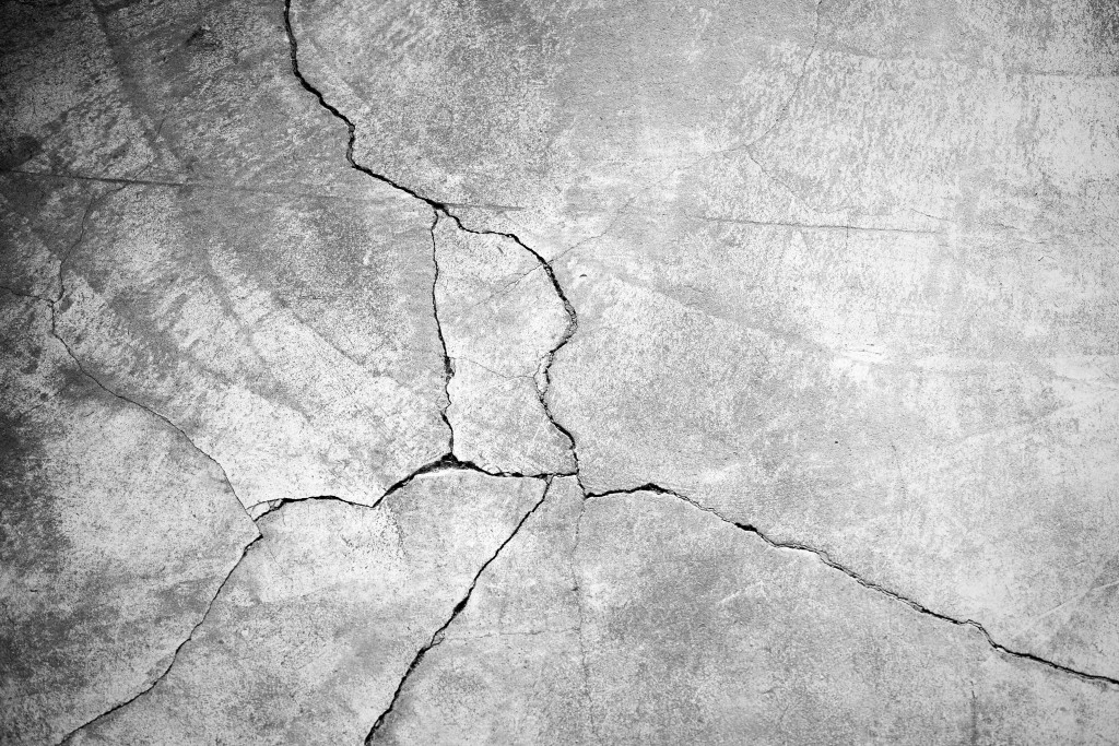 Grunge concrete cement wall with crack in industrial building