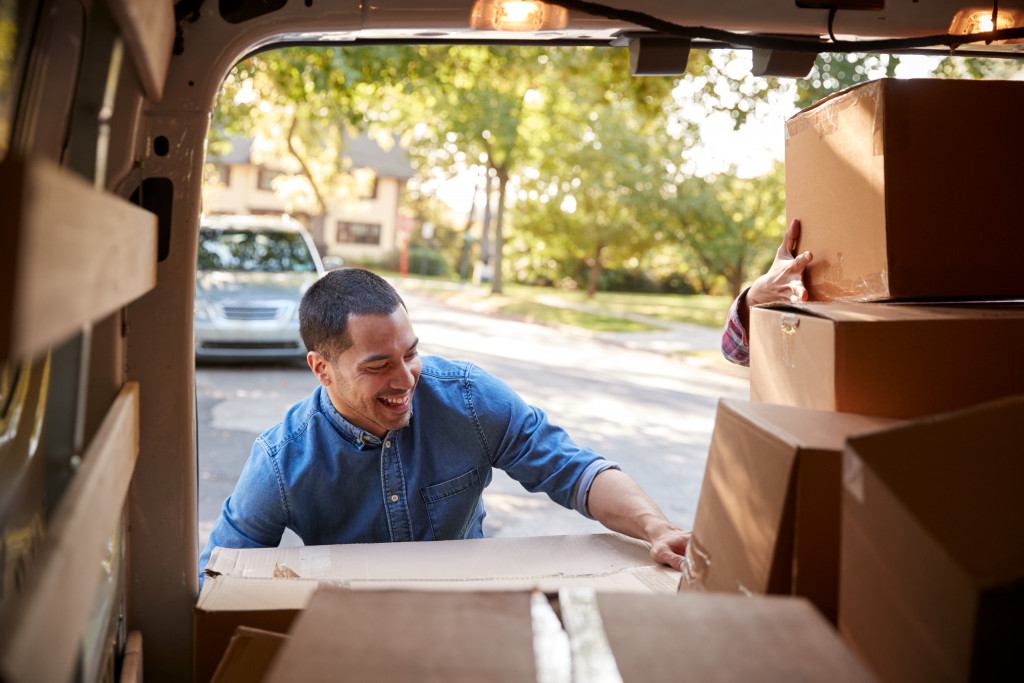 unloading boxes into van concept of cleaning out