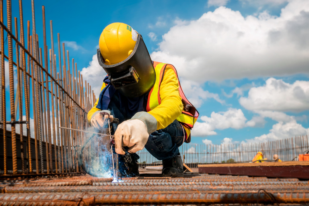 Construction worker wearing safety gear while working at a construction site.