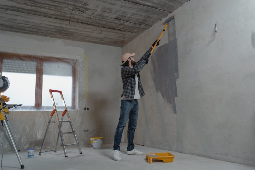 man painting home wall