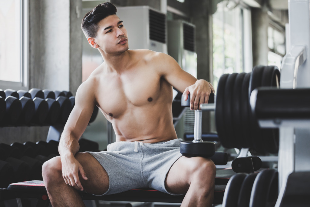 A guy sitting inside a gym