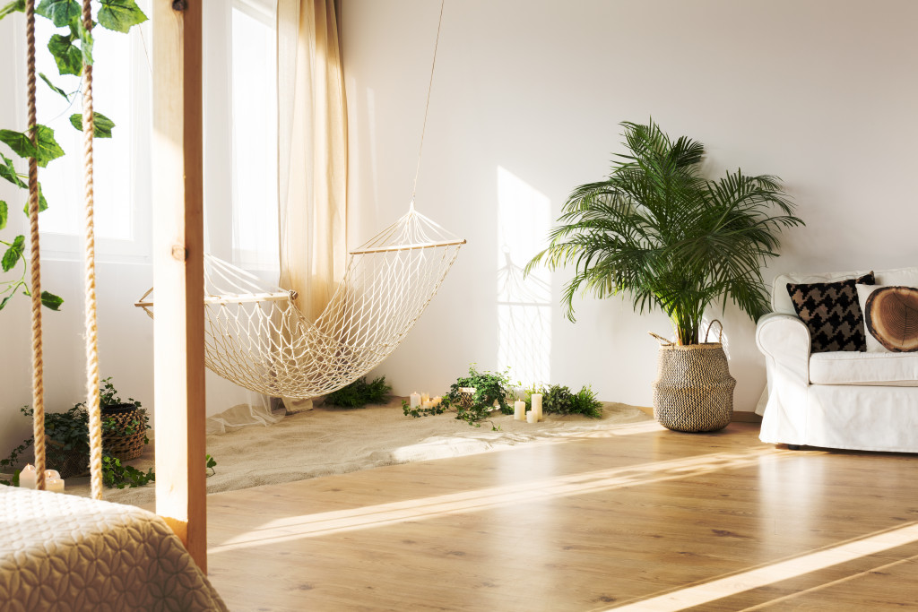 cozy and minimalist interior of a house with rope used as hammock and baskets