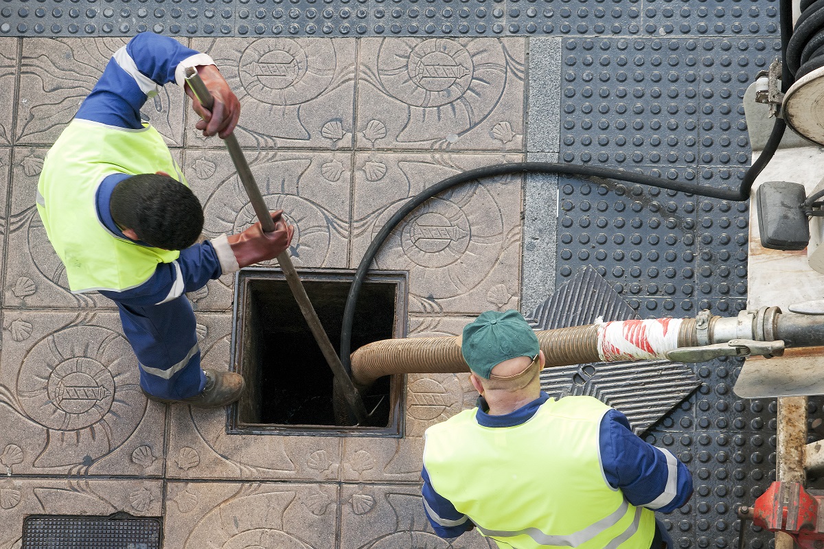 workers cleaning the sewer lines