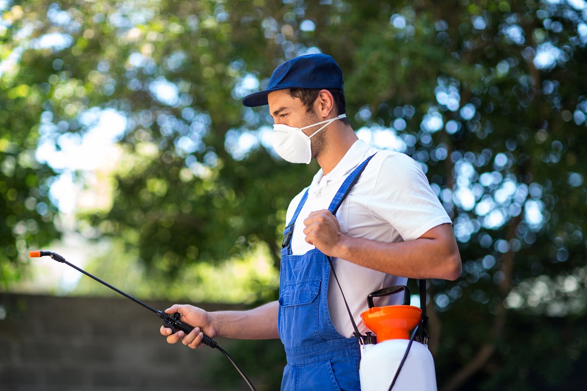 A pest control worker in a garden